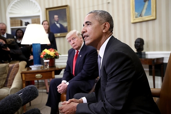 Donald Trump listens as Barack Obama speaks during a meeting in the Oval Office 10 November 2016 in Washington. Photo credit:Win McNamee/GettyImages