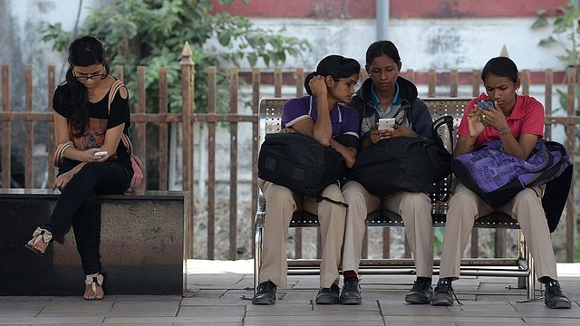 Indian women check their mobile telephones at a free Wi-Fi
Internet zone in Mumbai. Photo credit: INDRANIL MUKHERJEE/AFP/GettyImages &nbsp; &nbsp; &nbsp;