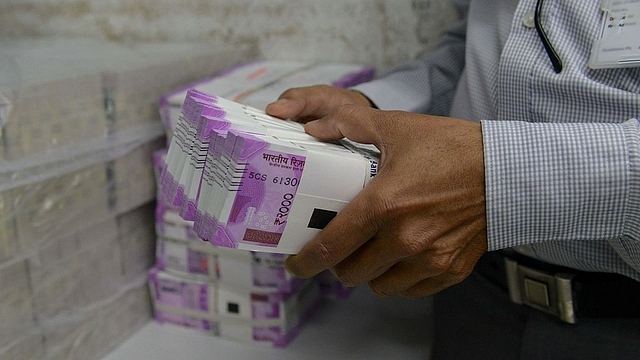 Representative image of stacks of cash (SAM PANTHAKY/AFP/Getty Images)