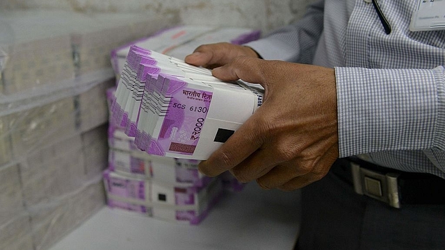 Representative image of stacks of cash (SAM PANTHAKY/AFP/Getty Images)