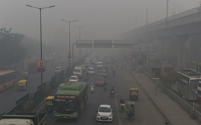 

Motorists drive on a major road as smog covers Delhi. Photo credit: PRAKASH SINGH/AFP/GettyImages