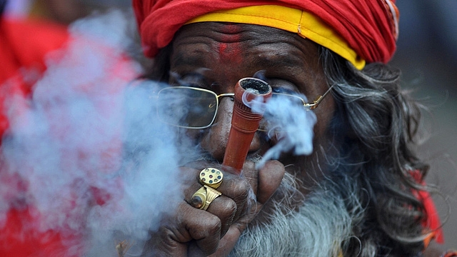 An Indian sadhu  puffs cannabis (BIJU BORO/AFP/Getty Images)