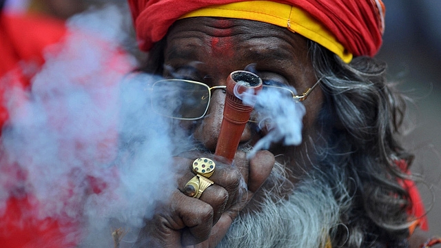 An Indian sadhu  puffs cannabis (BIJU BORO/AFP/Getty Images)