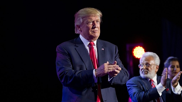 President-elect Donald Trump applauds the crowd after speaking at a Hindu political organisation’s anti-terror fundraiser. Photo credit: DOMINICK REUTER/AFP/Getty Images