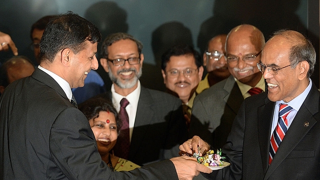 

Reserve Bank of India’s (RBI) newly appointed governor Raghuram Rajan (L) offers sweets to outgoing governor Duvvuri Subbarao (R) during the hand over ceremony at the RBI headquarters in Mumbai on September 4, 2013. Top economist Raghuram Rajan, renowned for predicting the 2008 global financial crisis, takes over as head of India’s central bank on September 4, amid the country’s worst financial storm in years. AFP PHOTO/ PUNIT PARANJPE (Photo credit should read PUNIT PARANJPE/AFP/Getty Images)