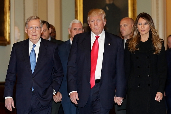 

US President-elect Donald Trump walks with his wife Melania Trump and Vice President-elect Mike Pence before a meeting with Senate Majority Leader Mitch McConnell on Capitol Hill in Washington, DC on November 10, 2016. Photo credit: YURI GRIPAS/AFP/GettyImages