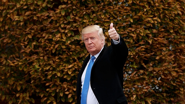 President-elect Donald Trump waves as he arrives at Trump International Golf Club for a day of meetings in Bedminster Township, New Jersey. (Drew Angerer/Getty Images)