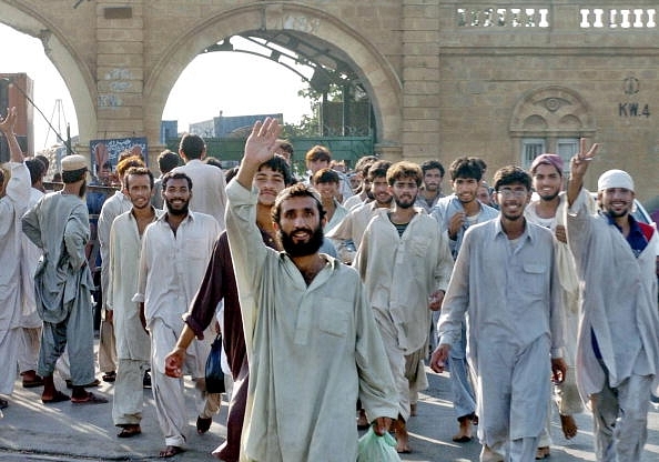 Pakistani deportees gesture as they leave Karachi Port Trust in Karachi following their deportation from Muscat. (ASIF HASSAN/AFP/Getty Images)