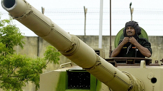 An Indian crew member stands in a main battle tank Arjun as he prepares for its roll out ceremony at the Heavy Vehicle Factory in Avadi some 35km south-west of Chennai.  Photo credit:  DIBYANGSHU SARKAR/AFP/GettyImages