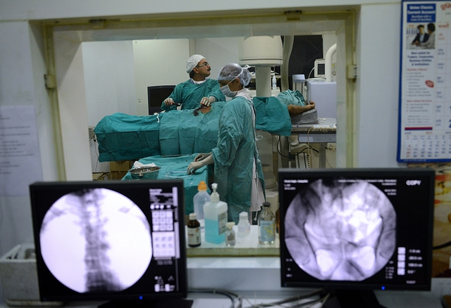 
Indian surgeon, Manish Raval, left, infuses stem cells to patient, Sampath Kumar. Photo credit: SAM PANTHAKY/AFP/GettyImages

