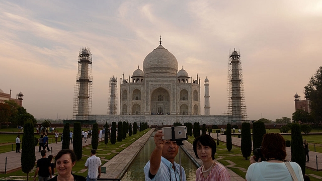 
Tourists take a Selfie as they visit the Taj Mahal in Agra. (MONEY SHARMA/AFP/Getty Images)

