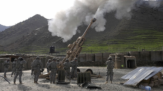 
US soldiers fire shots using an M-777 howitzer. Photo credit: LIU JIN/AFP/GettyImages

