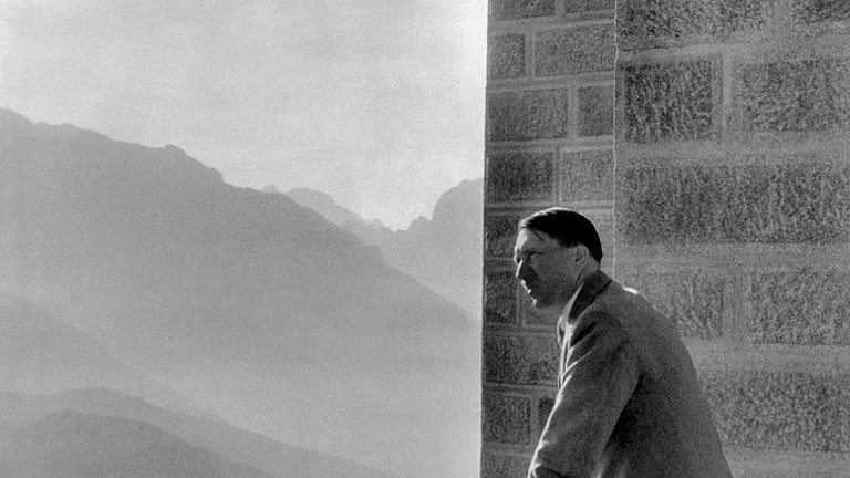 Adolf Hitler looking at the Obersalzberg Mountains from a balcony of his Berghof residence near Berchtesgaden. (Photo credit - /AFP/Getty Images)