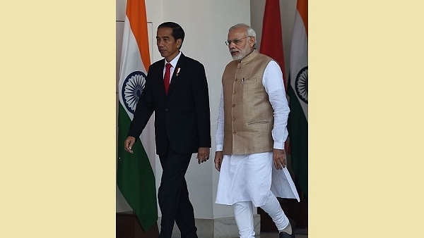 Prime Minister Narendra Modi (R) arrives with the Indonesia President Joko Widodo for a meeting at the Hyderabad House in New Delhi. (MONEY SHARMA/AFP/Getty Images)