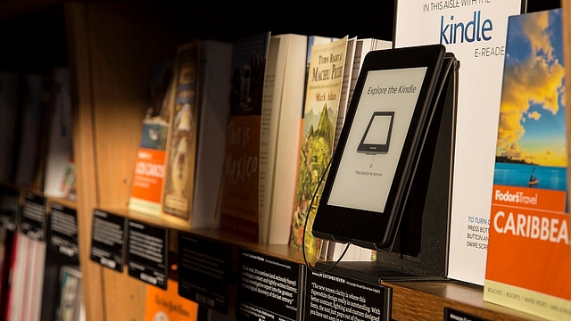 
Books are displayed along side an Amazon
 Kindle device. Photo credit: Stephen Brashear/GettyImages

