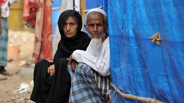 Rohingya Muslim man Ahammed Khabhir and his wife sit outside their tent  in the old city of Hyderabad. (NOAH SEELAM/AFP/Getty Images)
