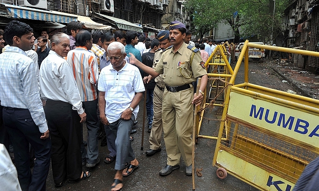 
Indian police officials move crowds along near a bomb blast site. (INDRANIL MUKHERJEE/AFP/Getty Images)

