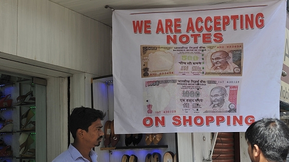 An Indian vendor displays a sign advertising acceptance of
banned Rs 500 and Rs 1,000 notes as he waits for customers at a shoe shop in
Hyderabad. Photo credit: NOAH SEELAM/AFP/GettyImages