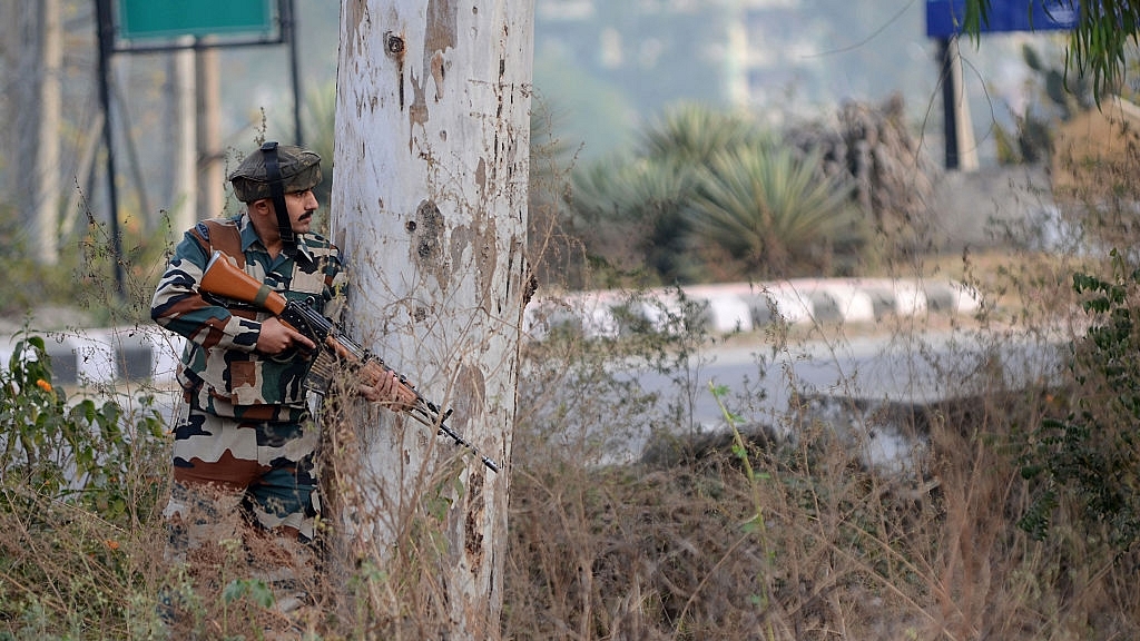 Indian army soldier stands guard during a gun battle. (STRINGER/AFP/Getty Images)