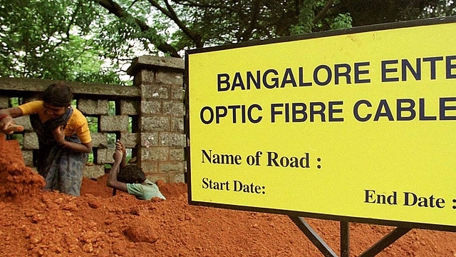 Workers dig up a trench before laying fibre optic cables in Bengaluru. (INDRANIL MUKHERJEE/AFP/Getty Images)