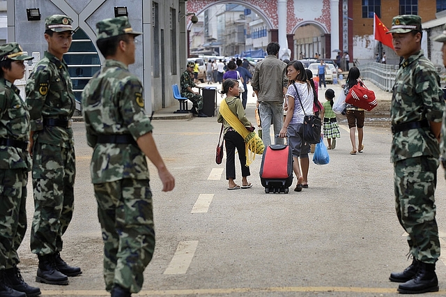 
File picture: Chinese soldiers stand guard as refugees cross the border towards 
Myanmar on 31 August 31, 2009. Photo 
credit: PHILIPPE LOPEZ/AFP/GettyImages

