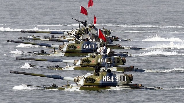 Amphibious tanks of the Chinese People’s Liberation Army move to land a beach. (China Photos/Getty Images)