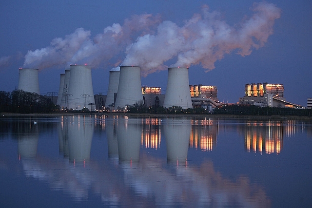 Exhaust plumes from cooling towers at the Jaenschwalde lignite coal-fired power station at Jaenschwalde, Germany. (Sean Gallup/Getty Images)