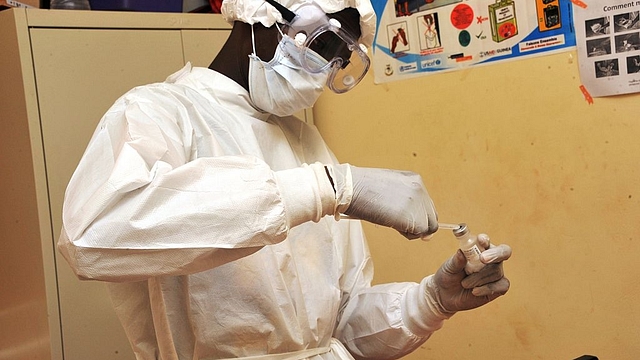 A health worker prepares a vaccination at a health centre during the first clinical trials of the VSV-EBOV vaccine against the Ebola virus. (CELLOU BINANI/AFP/Getty Images)