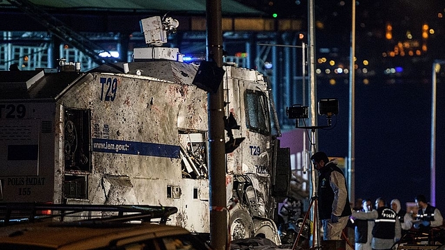 Turkish forensic police officers work at the site where a car bomb exploded near the stadium of football club Besiktas in central Istanbul. (OZAN KOSE/AFP/Getty Images)