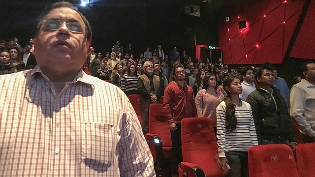 Audience members stand for the Indian national anthem before a movie starts at a cinema in New Delhi. (CHANDAN KHANNA/AFP/Getty Images)