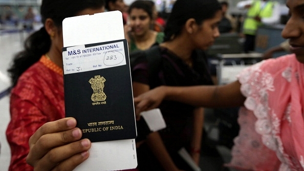 An Indian woman holds up her passport (SAFIN HAMED/AFP/Getty Images)