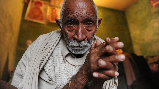 

 Hindu refugee from West Pakistan, Mangu Ram (82) sits inside his concrete shanty in Surej Chak, on the outskirts of Jammu. (TAUSEEF MUSTAFA/AFP/Getty Images)