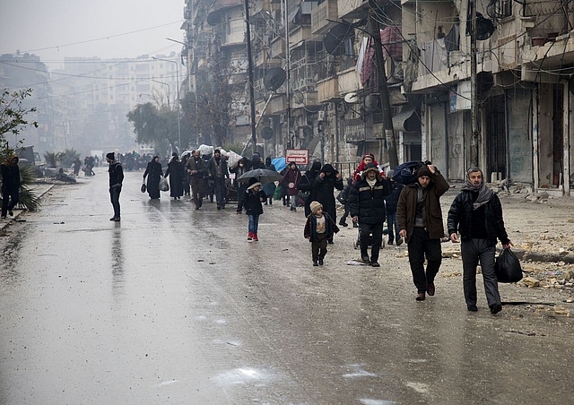 Syrians leave a rebel-held area of Aleppo towards the government-held side during an operation by Syrian government forces to retake the embattled city. (KARAM AL-MASRI/AFP/Getty Images)