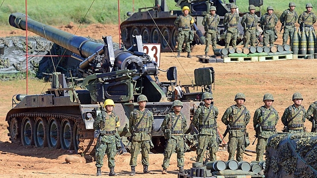 Taiwan military soldiers stand guard next to a 155mm howitzer during the Han Kuang 31 live fire drill in Hsinchu, northern Taiwan. (SAM YEH/AFP/Getty Images)