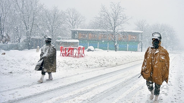 Indian paramilitary troopers patrol during heavy snowfall in
Gund, some 70km northeast from Srinagar. (TAUSEEF MUSTAFA/AFP/GettyImages)