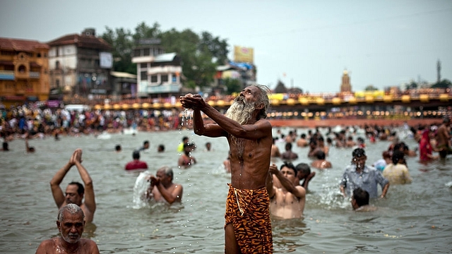 Hindu devotees bathe during the second ‘Shahi Snan’ (grand bath) of Kumbh Mela in the Godavari river, 2015, in Nashik. (Allison Joyce/Getty Images)