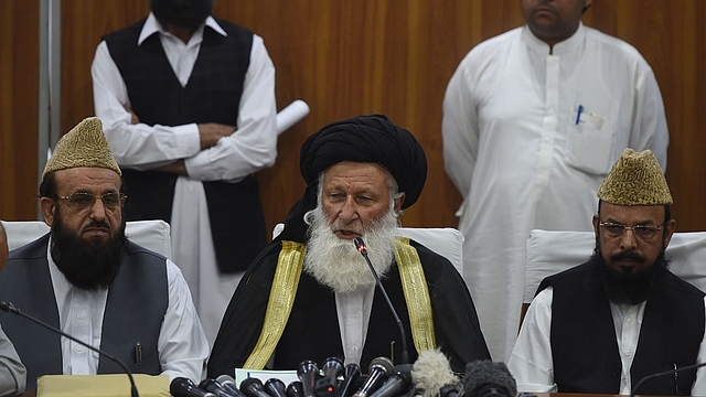 Council of Islamic Ideology (CII) chairman Maulana Muhammad Khan Sherani (C) addresses a press conference in Islamabad. (FAROOQ NAEEM/AFP/Getty Images)