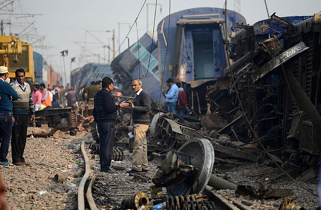 
Indian officials gather at the wreckage of train carriages at 
Rura. (SANJAY 
KANOJIA/AFP/Getty Images)

