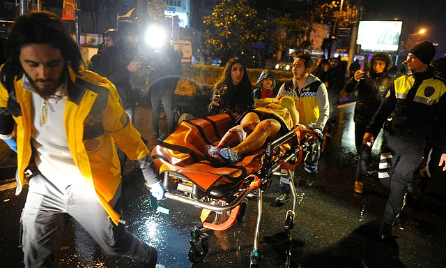 

First-aid officers carry an injured woman at the site of the armed attack in Istanbul. (GettyImages)