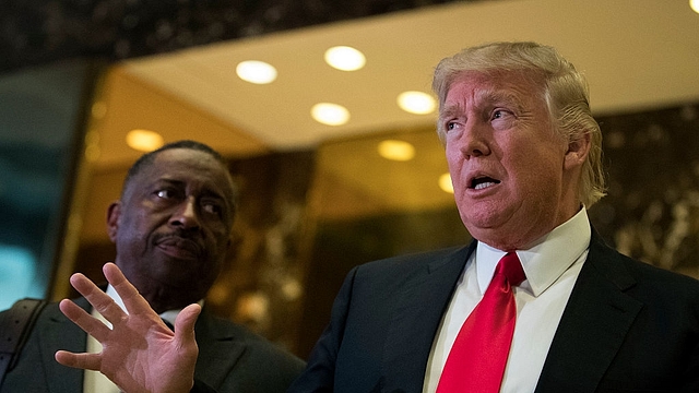 Businessman Greg Calhoun looks on as President-elect Donald Trump speaks to reporters. (Drew Angerer/Getty Images)