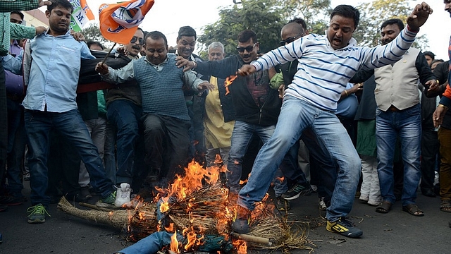 Trinamool Congress supporters shout slogans as they burn an effigy of Prime Minister Narendra Modi during a protest meeting in Siliguri. (DIPTENDU DUTTA/AFP/GettyImages)