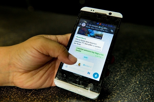 A person chats on a mobile
phone. (FEDERICO PARRA/AFP/Getty Images)&nbsp; &nbsp;