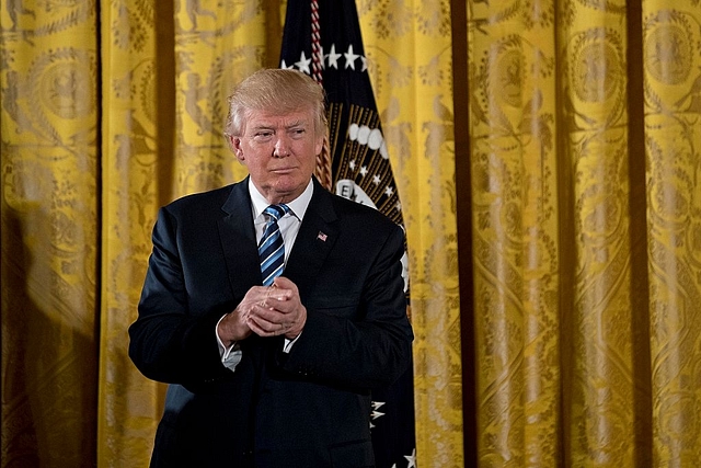 
U S President Donald Trump listens 
during a swearing in ceremony. (Andrew Harrer-Pool/Getty Images)

