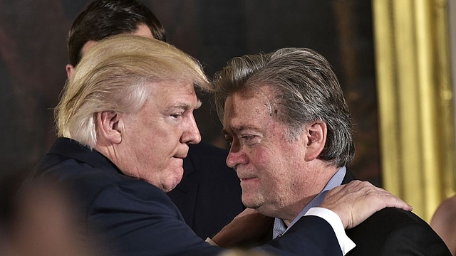 

US President Donald Trump  congratulates Senior Counselor to the President, Stephen Bannon during the swearing-in of senior staff. (MANDEL NGAN/AFP/GettyImages)