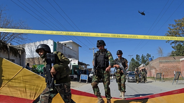 Pakistani soldiers arrive at the site of a court complex after multiple Taliban suicide bombings in the Tangi area of Charsadda district. (ABDUL MAJEED/AFP/Getty Images)