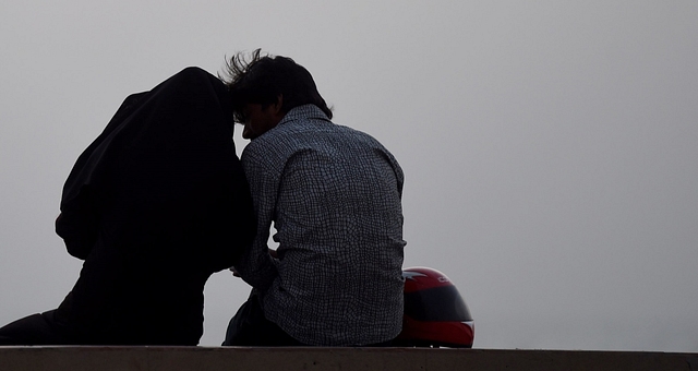 Pakistani couple sits on a beach on Valentine’s Day in Karachi on February 14, 2016. (Photo credit SIF HASSAN/AFP/Getty Images)