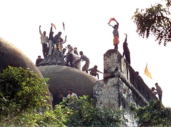 Kar sevaks atop the disputed structure (DOUGLAS E. CURRAN/AFP/Getty Images) 