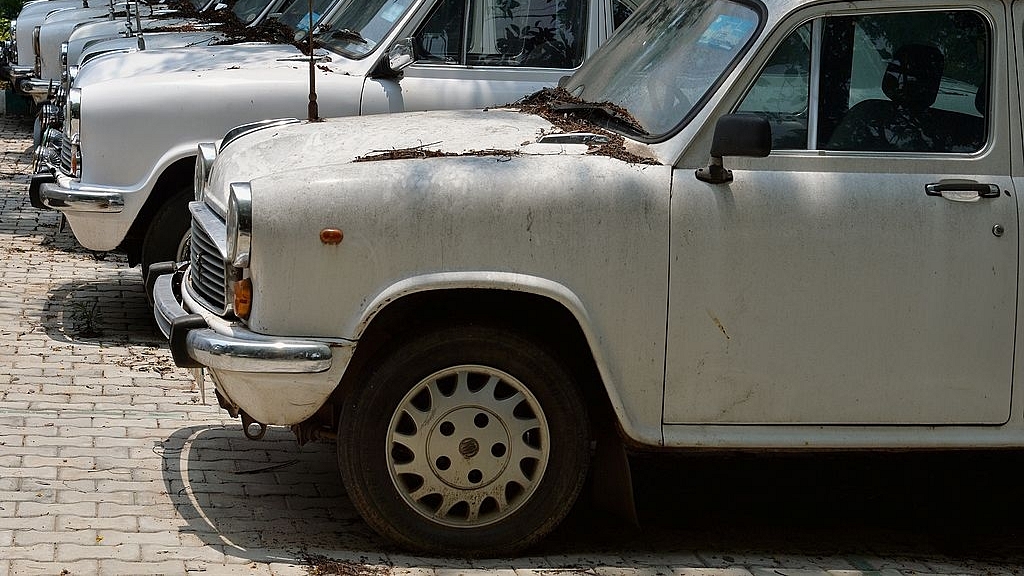 

Defunct Ambassador cars of the state government gather dust at a parking lot in Bengaluru.(MANJUNATH KIRAN/AFP/GettyImages)