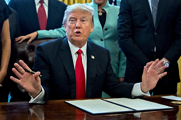 

Donald Trump signing an executive order. (Andrew Harrer - Pool/GettyImages)