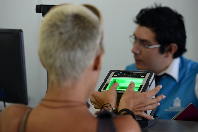 A woman has her fingerprints scanned at an airport in Honduras. Representative Image. (Photo credit ORLANDO SIERRA/AFP/Getty Images)